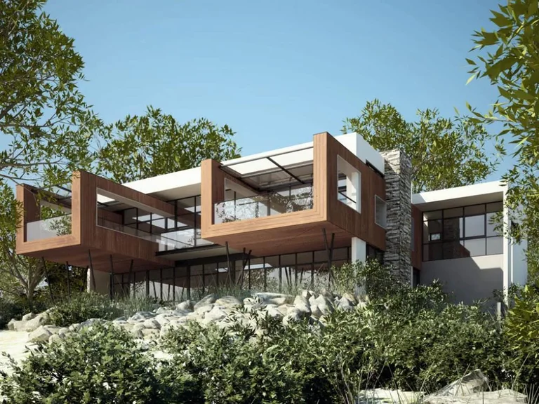 Augusta House — cantilevered upper levels with timber cladding and a stacked-stone wall above a rocky coastal site