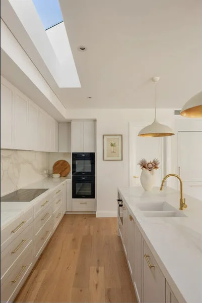 Kitchen with stone benchtops and a long skylight, Cottesloe