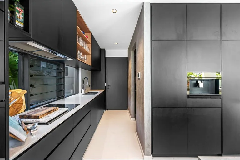 Kitchen with dark joinery and stone benchtops, Hawkstone project