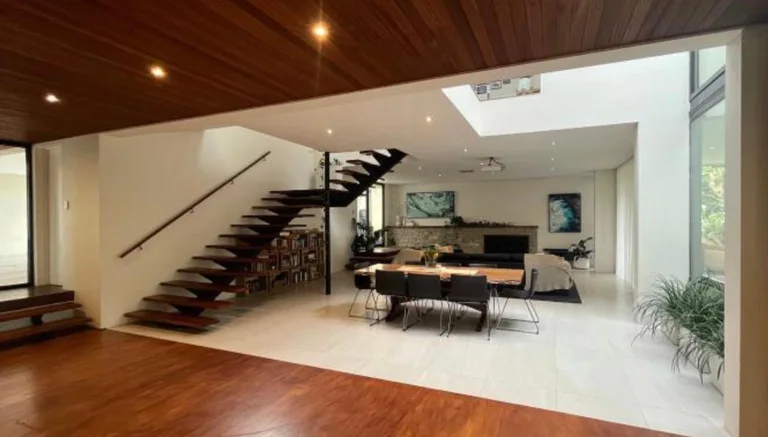 Open-plan living with floating steel-and-timber stair and timber-lined ceiling, Wembley Downs
